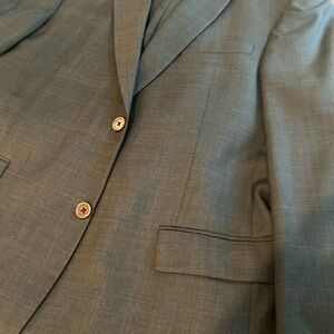 Tommy Hilfiger Gray Suit with Notched Lapel
Pleated, cuffed slacks.